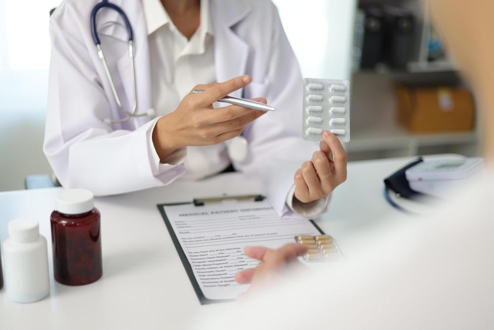 Doctor reviewing ALS medication options with a patient as part of treatment planning for symptom progression