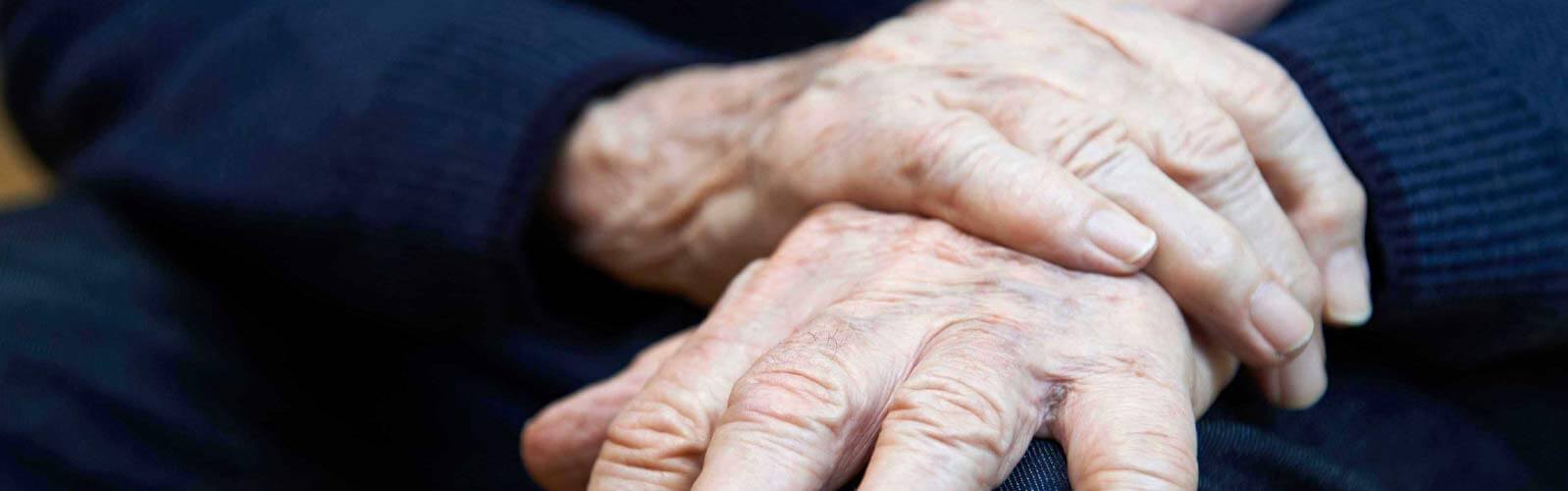 Older adult’s resting hands representing movement disorders and stem cell therapy for Parkinson’s disease